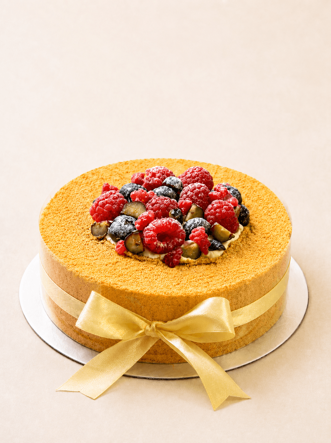 A sliced medovik honey cake showing eight thin layers and soured cream