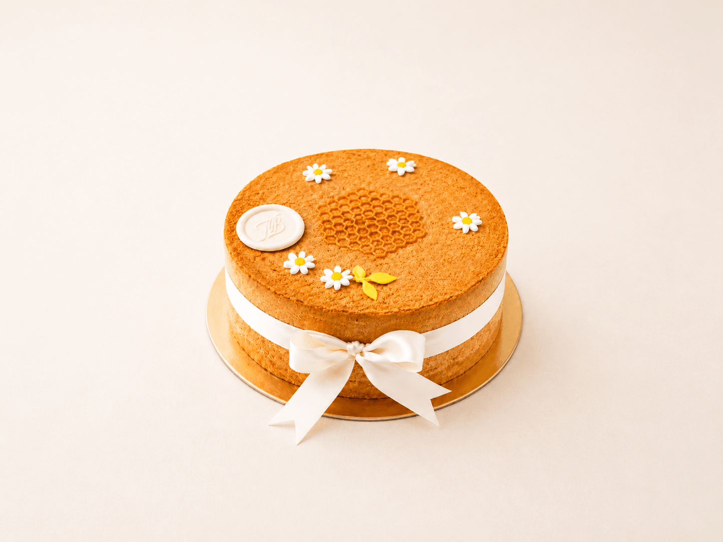 A sliced medovik honey cake showing eight thin layers and soured cream
