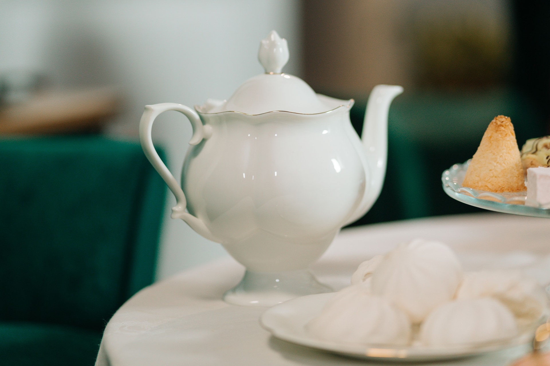An afternoon tea table set with pastries, cakes and a teapot